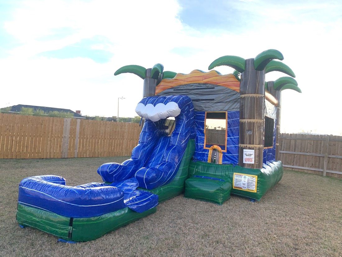 MonSoon Madness palm-tree water slide combo set up in a backyard