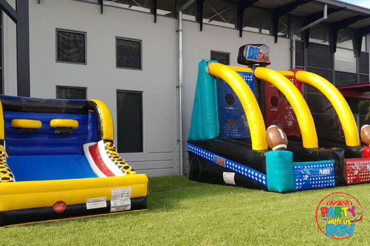 Inflatable obstacle course and sports game set up on grass